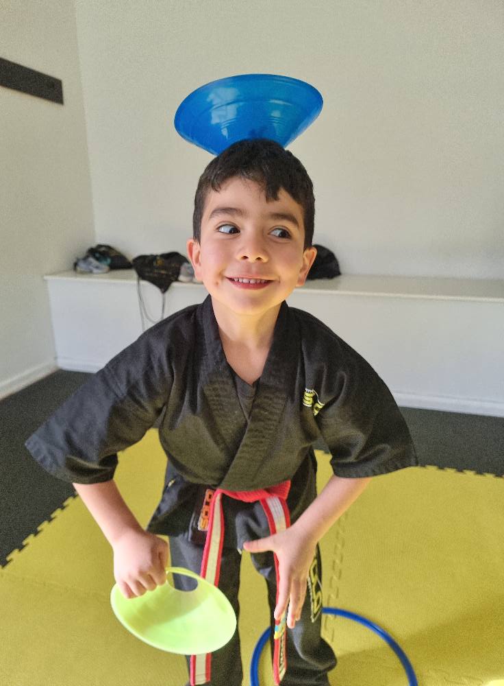 Kid balancing cone on his head